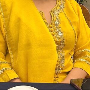 Embroidered Yellow Women's salwar suit with intricate zardousi work.